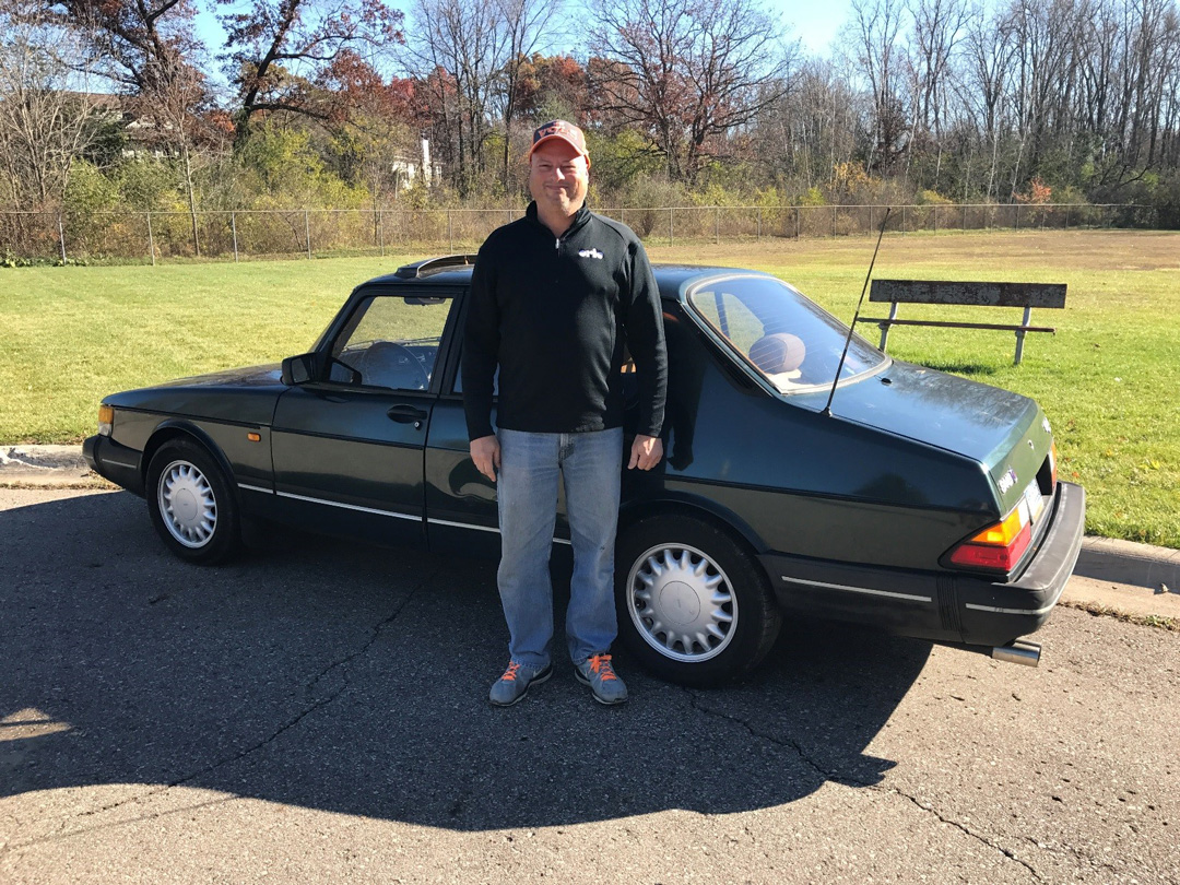 Smiling man at his Saab 900s 1993